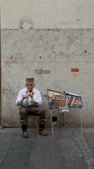 Traditional musician performs on Belgrade street near public fountain