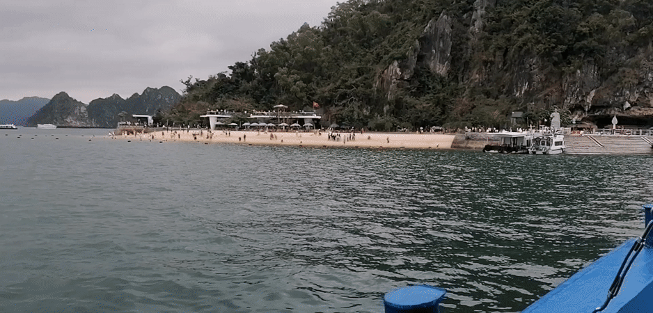 Tourist boats navigate Ha Long Bay under cloudy skies