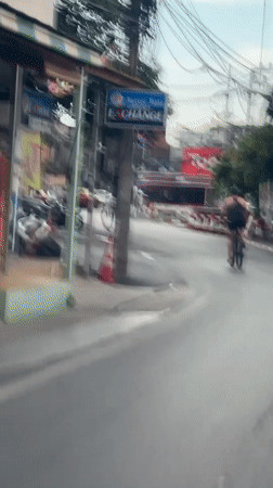Helmet-on cycling through wet Ko Samui streets