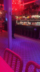 Couples dance in colorfully lit Pattaya bar establishment
