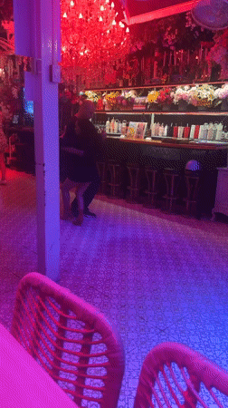 Couples dance in colorfully lit Pattaya bar establishment