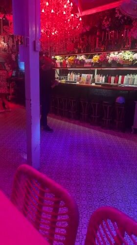 Couples dance in colorfully lit Pattaya bar establishment