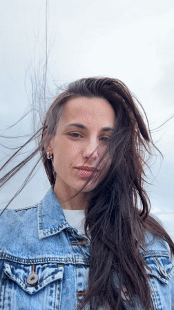 Woman enjoys morning coffee at rainy Chania beachside cafe