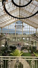 Inside a glass greenhouse café and gardens in Baturiti
