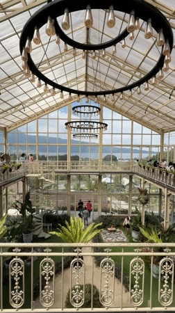 Inside a glass greenhouse café and gardens in Baturiti