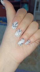 Person shows off silver marbled nail art in Tobolsk