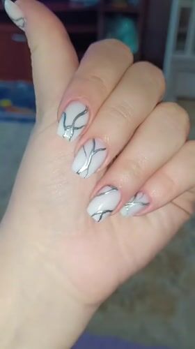 Person shows off silver marbled nail art in Tobolsk