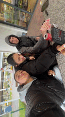 Three young adults take selfies at outdoor gas station gathering
