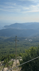 Paraglider soars over scenic Montenegro coastline near Boreti
