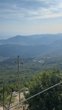 Paraglider soars over scenic Montenegro coastline near Boreti