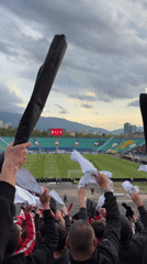 Football fans display banners during match in Sofia stadium