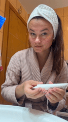 Woman's morning skincare routine documented in Montenegro bathroom