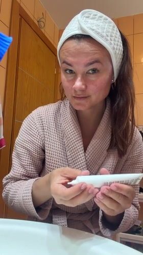 Woman's morning skincare routine documented in Montenegro bathroom