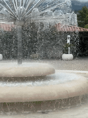 Budva fountain and casual mall visitor captured by witness
