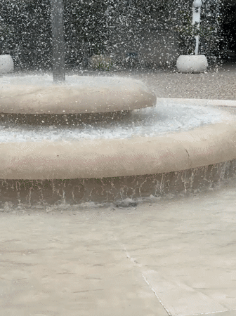 Budva fountain and casual mall visitor captured by witness