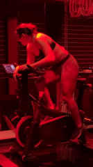Fitness instructor leads indoor cycling class in Puebla studio