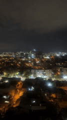 Aerial night footage captures Tbilisi cityscape panorama