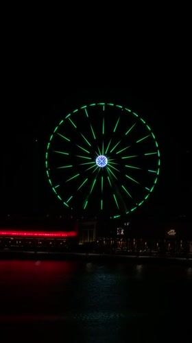 Colorful Ferris wheel light show captivates Lusail waterfront evening