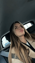 Woman in beige jacket observed in car backseat, Berlin