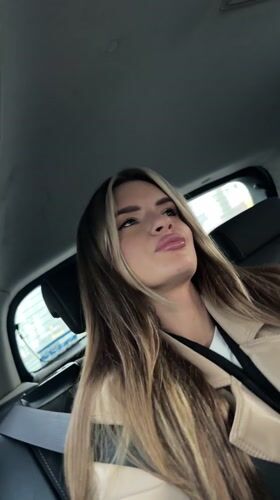 Woman in beige jacket observed in car backseat, Berlin
