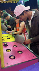 Young adults play arcade game in Thermal, California