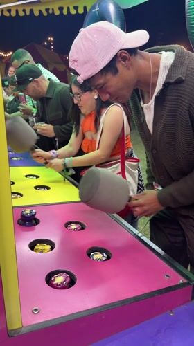 Young adults play arcade game in Thermal, California