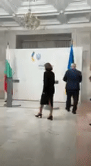 Official press conference held with formal backdrop and podiums