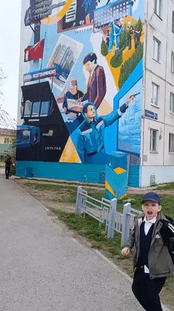 Children play at Tobolsk playground near historical mural