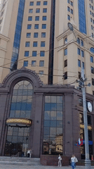 Mixed-architecture multi-story building exterior documented by witness
