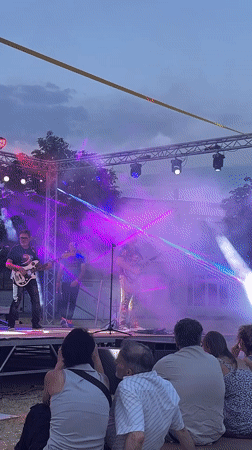 Live band on outdoor stage at twilight in Saint-Galmier