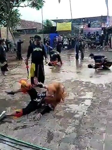 Traditional martial arts performance held in Indonesian village courtyard