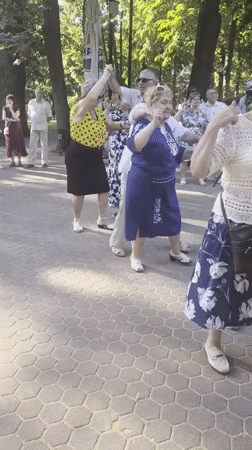 Outdoor folk dancing in a Chișinău park, midsummer afternoon