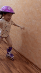 Child learns inline skating indoors during Chaikovsky sunset evening