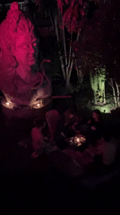Candlelit ceremonial gathering around illuminated sculptures in Mengwi, Indonesia