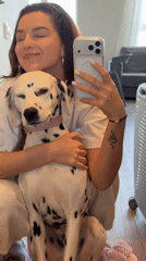 Woman documents morning routine with Dalmatian in Vladivostok selfies