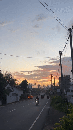 Evening traffic flows through Goviyapana during colorful sunset