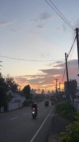 Evening traffic flows through Goviyapana during colorful sunset