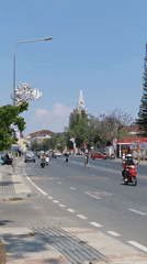 Morning traffic flows through Da Lat street scene