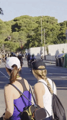 Triathlon cyclists race through sunny Grao streets