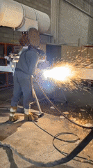 Welder performs metal fabrication at Montenegro industrial workshop