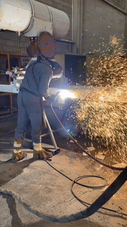 Welder performs metal fabrication at Montenegro industrial workshop