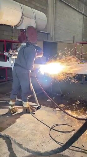 Welder performs metal fabrication at Montenegro industrial workshop