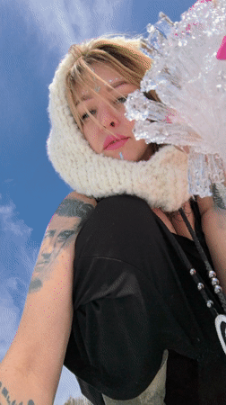Woman poses with ice shards in snowy Chaikovsky field