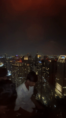 Rooftop bar buzzes with activity overlooking Bangkok skyline