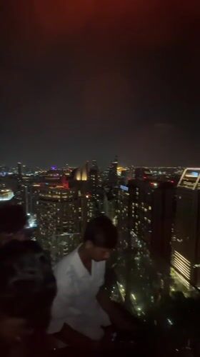 Rooftop bar buzzes with activity overlooking Bangkok skyline