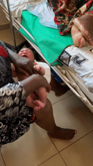 Newborn receives first care and bath in Jos, Nigeria
