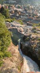 Alpine waterfall and mountain pool captured above Swiss town