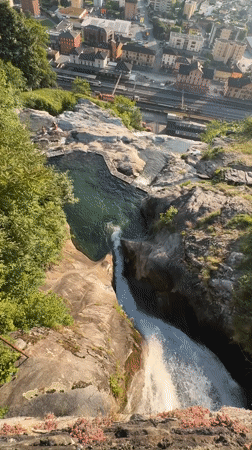 Alpine waterfall and mountain pool captured above Swiss town