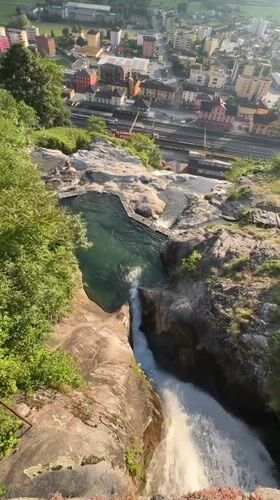 Alpine waterfall and mountain pool captured above Swiss town