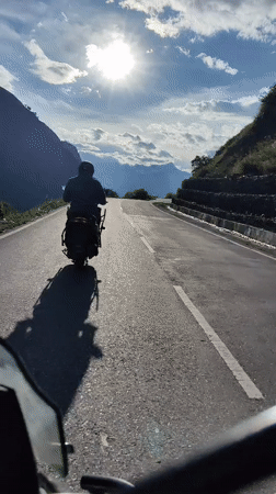 Scooter ride through a sunny mountain road in Ropsang